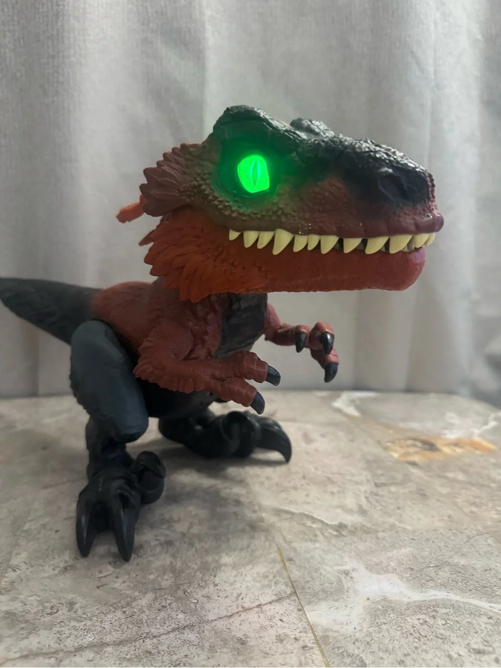 Red and Black Interactive Reptile Toy with Glowing Eye